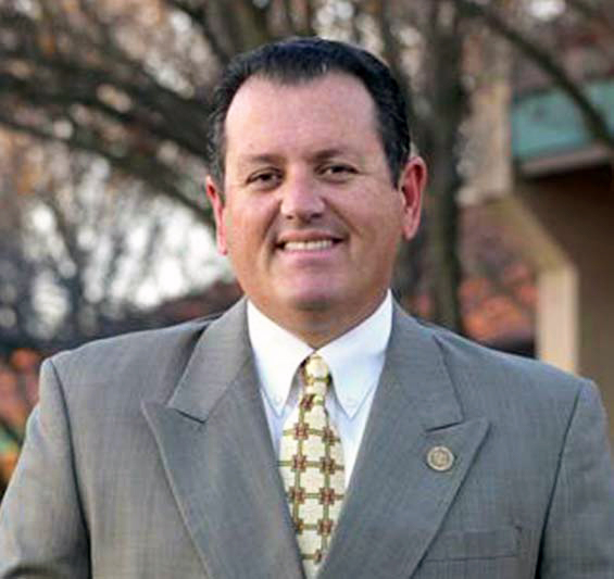 photo of Dr. Brescia superintendent of slo county schools, wearing a suit and smiling at camera